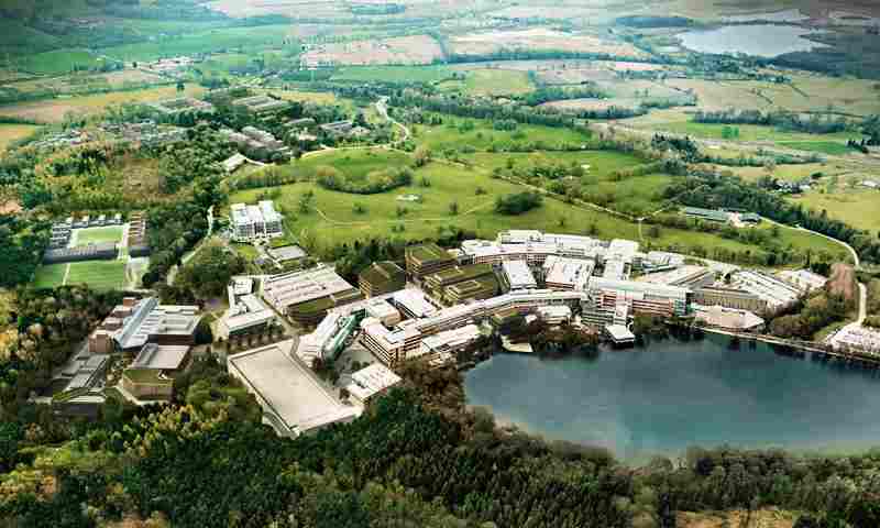 Aerial image of an industrial park called Alderley Park. There is an ornamental lake in front of the industrial park.