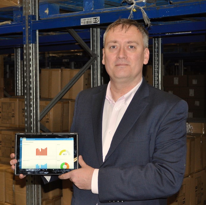 Gareth Dodd, chief technology office at OMS, holding a tablet whose display shows the company's software product