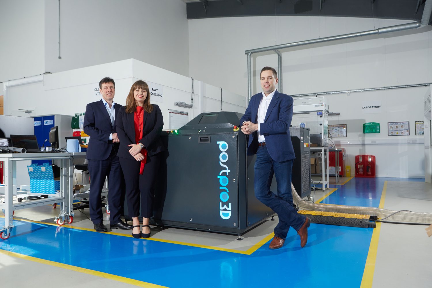 2 men and a woman from Additive Manufacturing Technologies stood next to a 3D printer