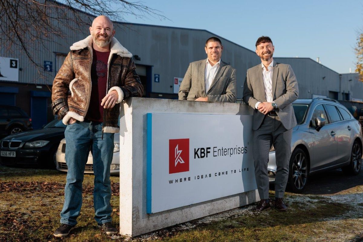 KBF Enterprises in front of sign